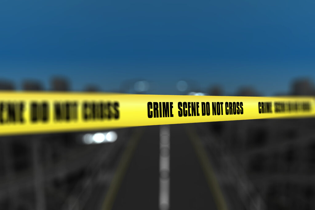 D police line tape against defocussed city background