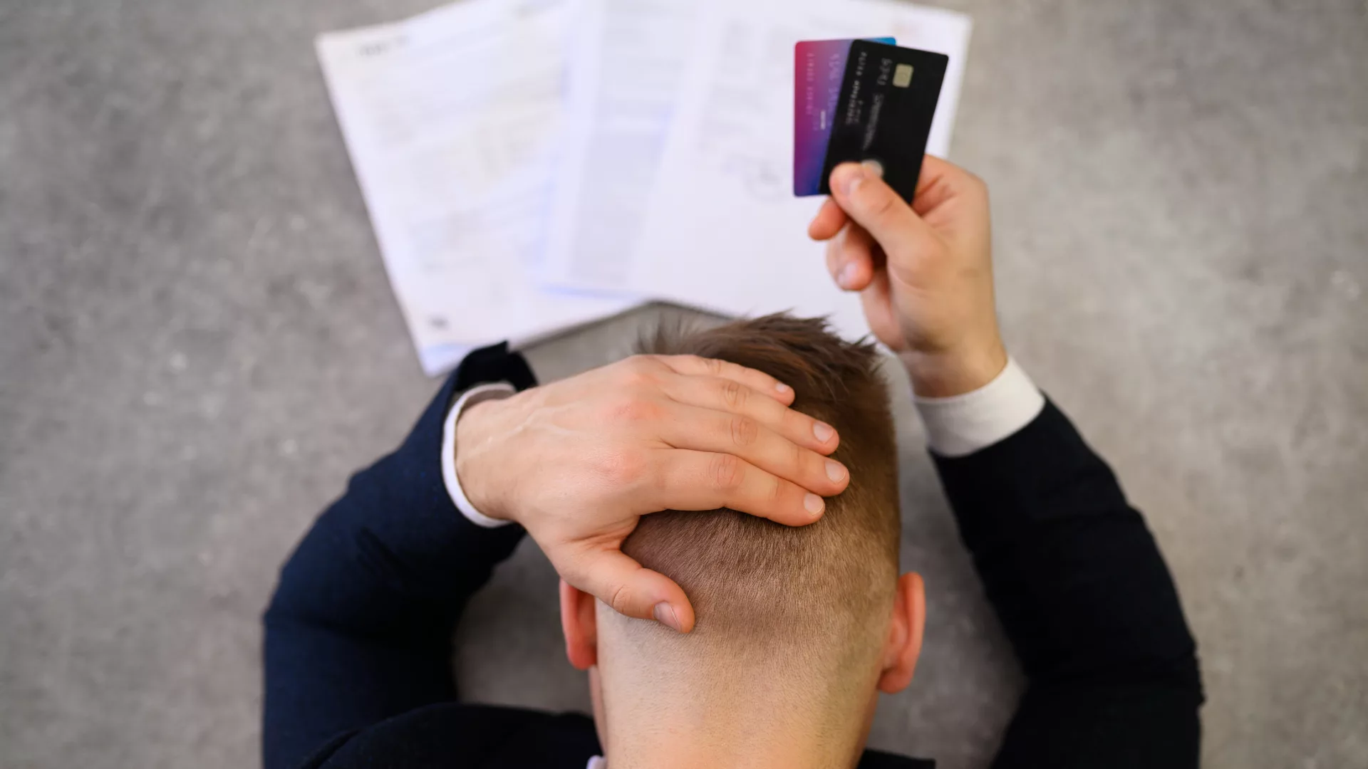 Person stressed with credit cards
